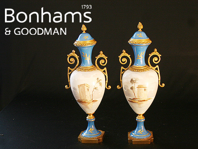 Appraisal: A pair of Sevres style lidded vases painted with scenes