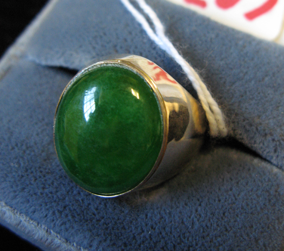 Appraisal: MAN'S JADE AND FOURTEEN KARAT GOLD SOLITAIRE RING centering an