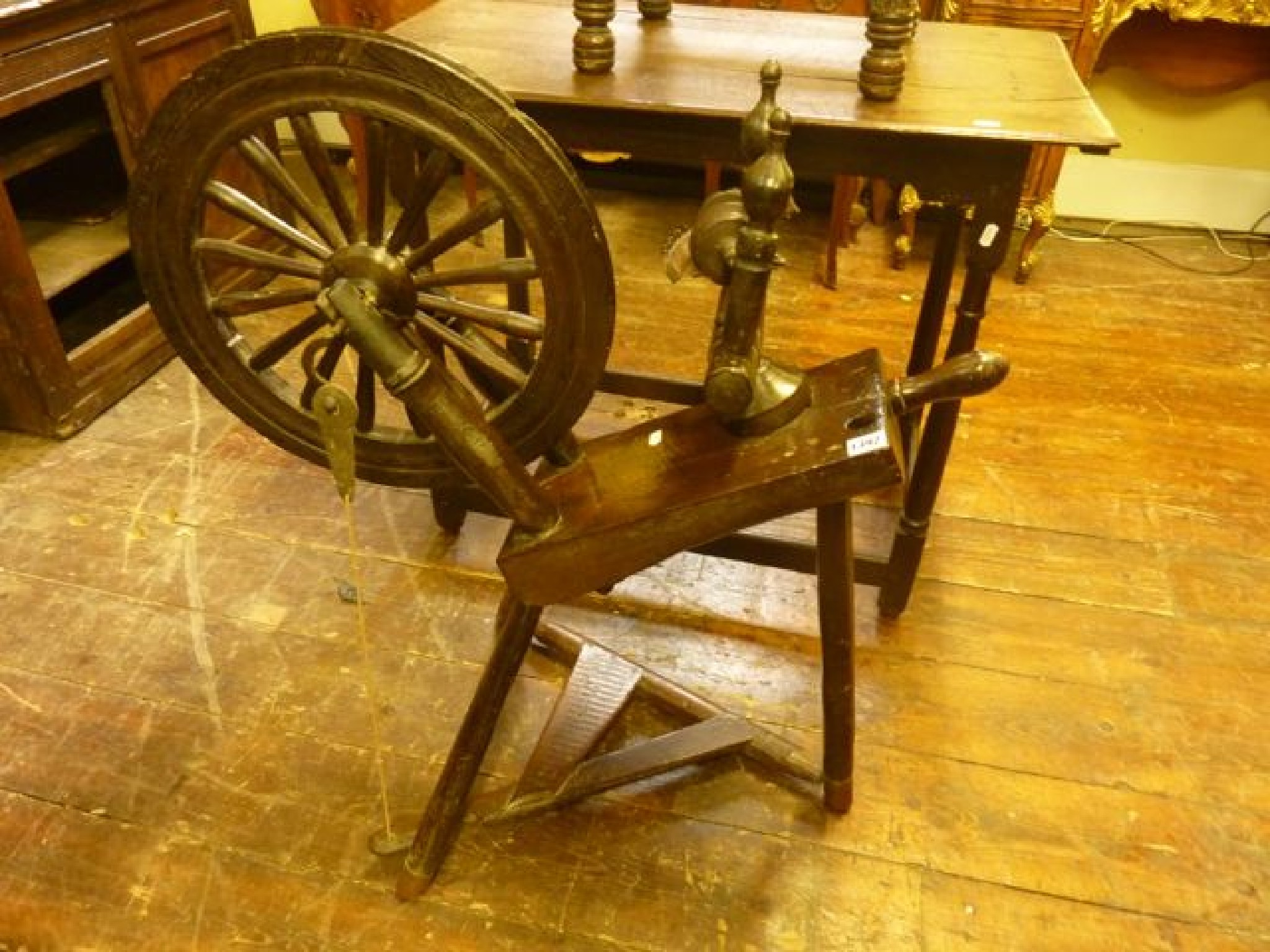 Appraisal: A Georgian oak country made spinning wheel the tripod base