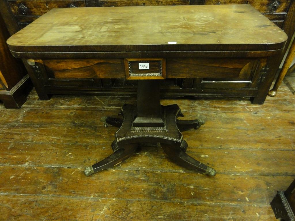 Appraisal: A Regency rosewood foldover top card table raised on a