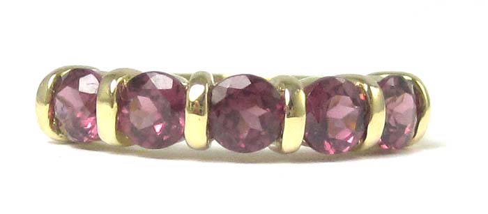 Appraisal: RHODOLITE AND FOURTEEN KARAT GOLD RING set with five round-cut