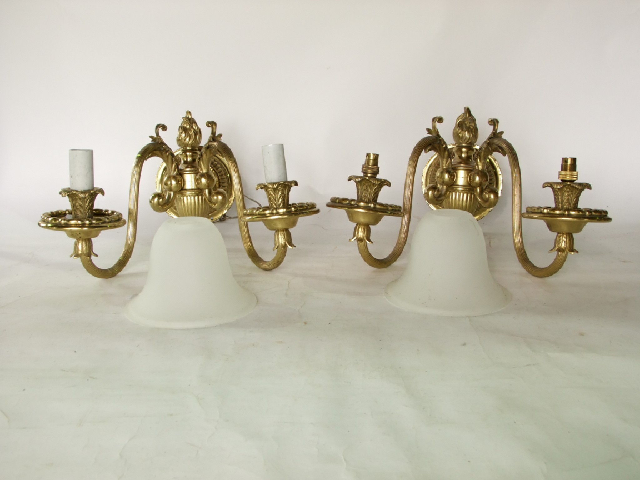 Appraisal: A pair of good quality brass wall lights each with