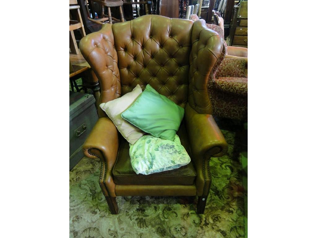 Appraisal: A Georgian style wing armchair with leatherette upholstered finish with