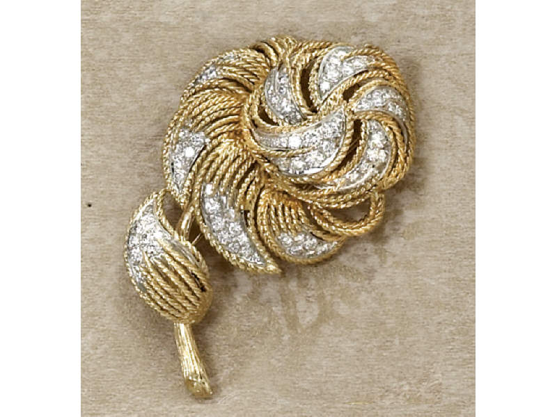 Appraisal: FLORAL DIAMOND BROOCH k yellow gold and platinum stylized floral