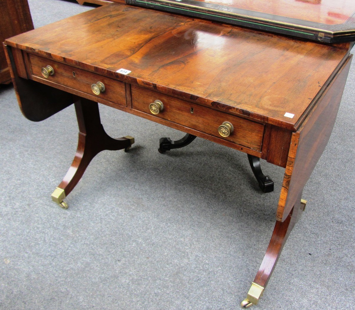 Appraisal: A Regency rosewood sofa table with two frieze drawers and