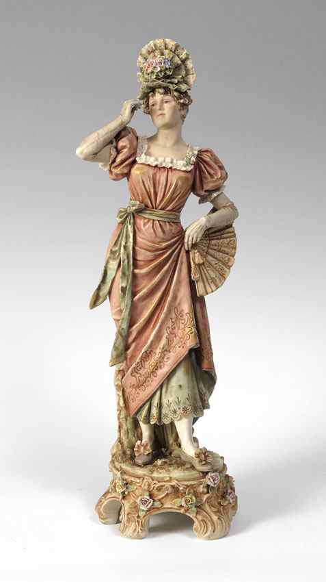 Appraisal: CONTINENTAL FIGURE OF A FINELY DRESSED WOMAN Slightly iridescent glaze