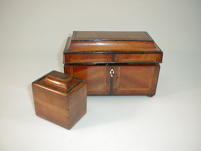 Appraisal: A George III mahogany tea caddy with three lidded canister