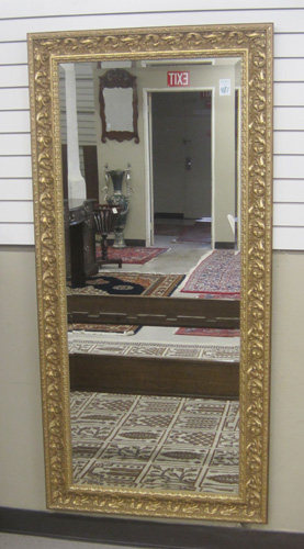 Appraisal: RECTANGULAR BEVELED WALL MIRROR in ornate molded wood frame with