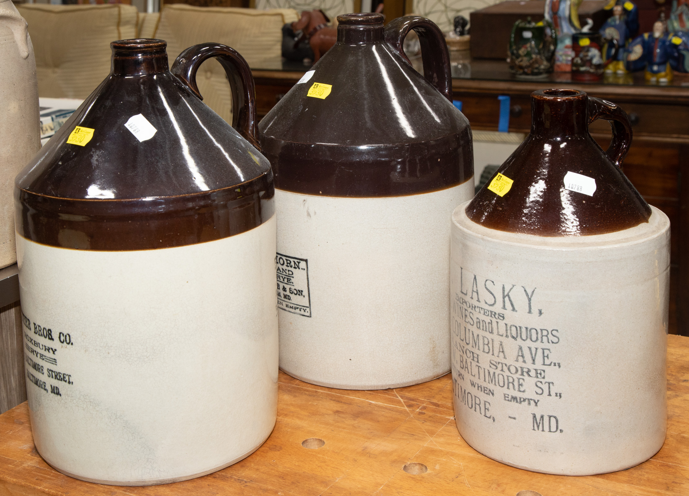 Appraisal: THREE BALTIMORE STONEWARE WHISKEY JUGS Late th century with stencil