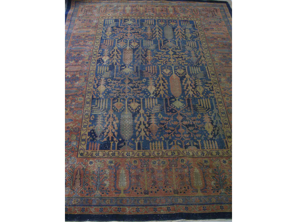 Appraisal: Semi-Antique Isparta Carpet center blue field of trees and shrubs