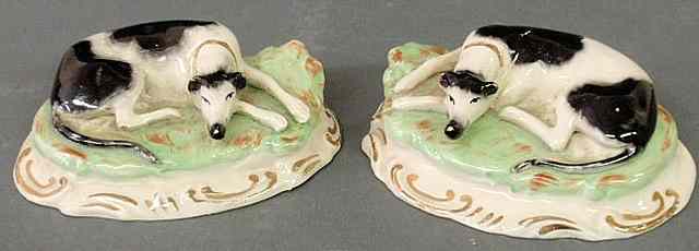 Appraisal: Pair of th c Staffordshire black and white whippets lying