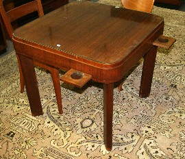 Appraisal: An Art Deco walnut veneered and glass topped card games