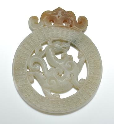 Appraisal: A Chinese Carved Two-Tone Jade Pendant Of round form carved