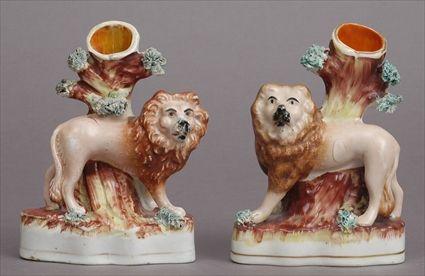 Appraisal: PAIR OF STAFFORDSHIRE LION-FORM SPILL VASES Each modeled walking with