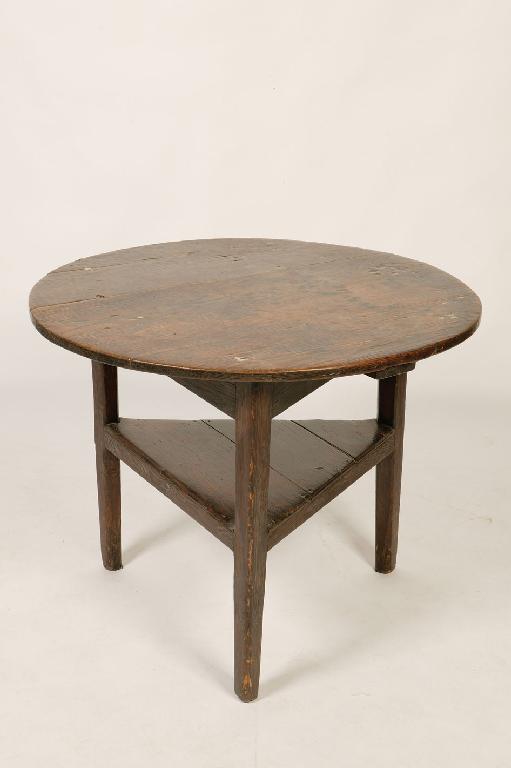 Appraisal: A PRIMITIVE CRICKET TABLE with a circular plank construction top