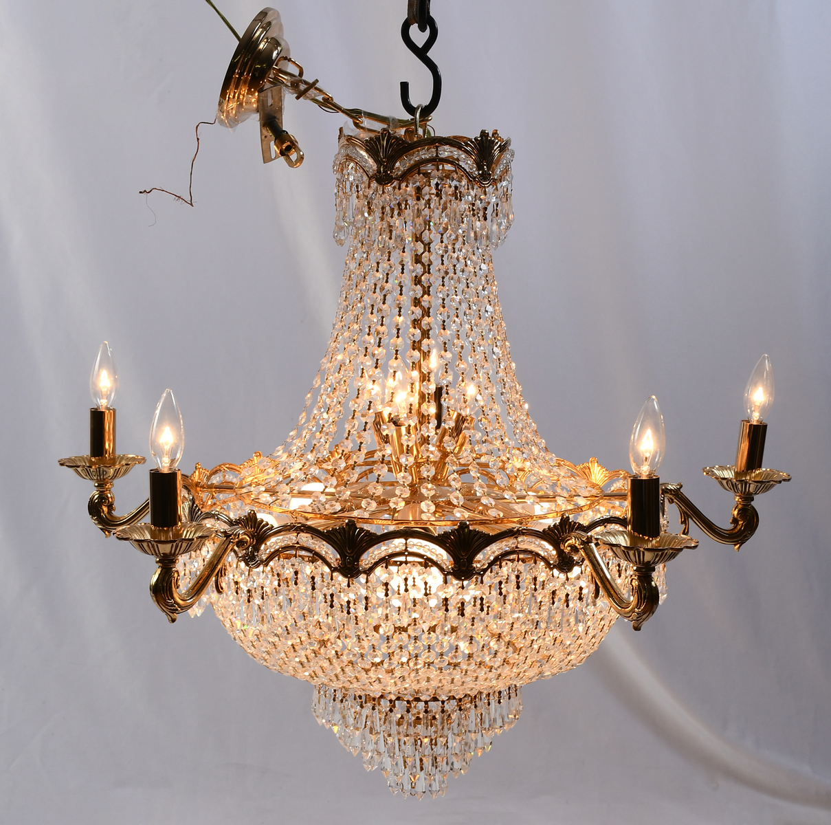 Appraisal: FRENCH LIGHT CRYSTAL CHANDELIER Gold toned folaite frame with draped