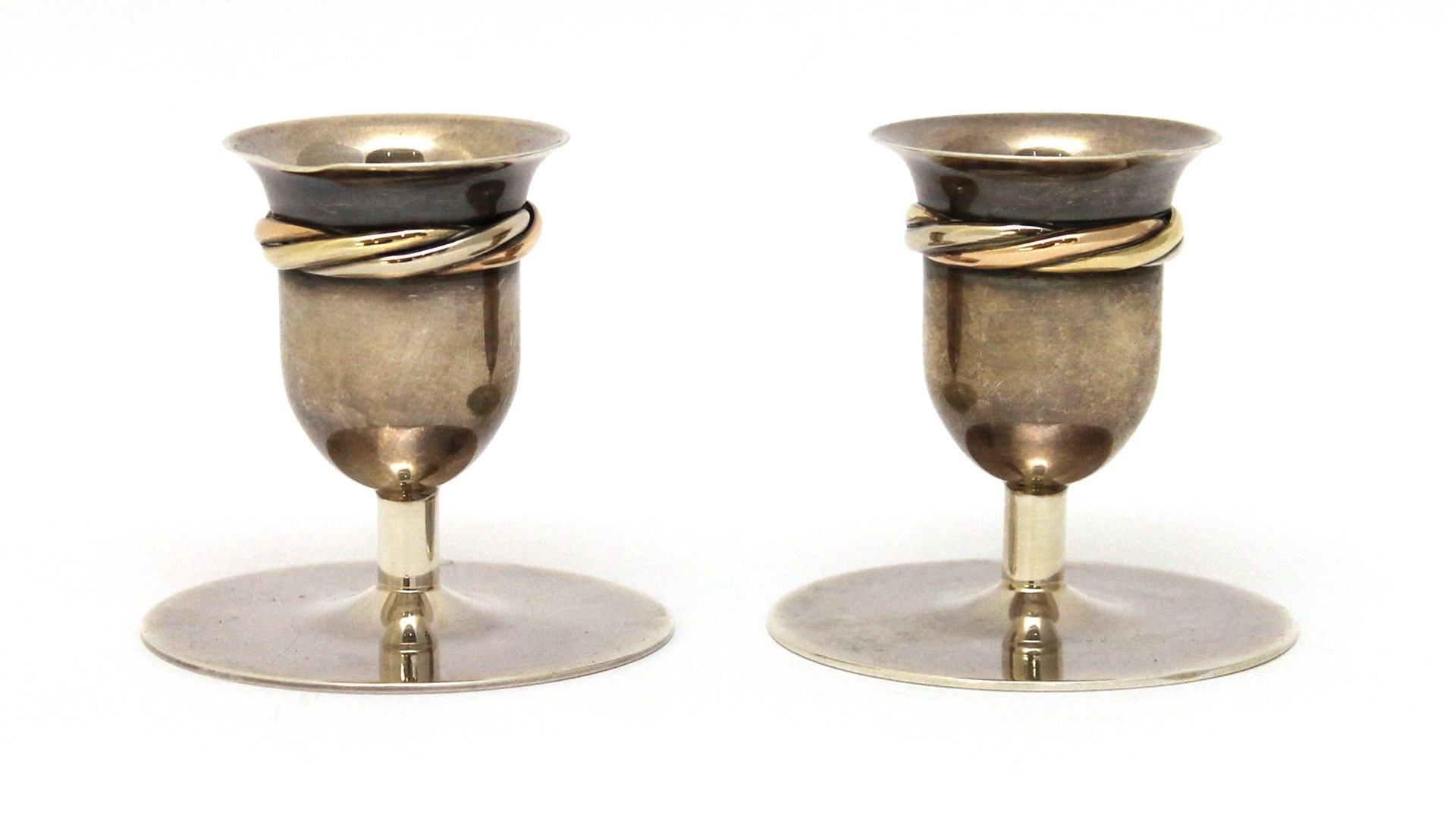 Appraisal: A pair of Cartier French silver small candlesticks each decorated