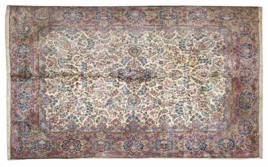 Appraisal: A Persian Kirman Wool Rug having allover foliate decoration on