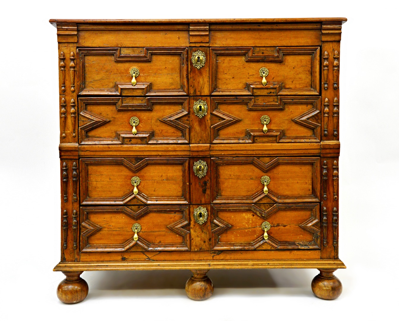 Appraisal: A Charles II geometric chest of drawers with four long