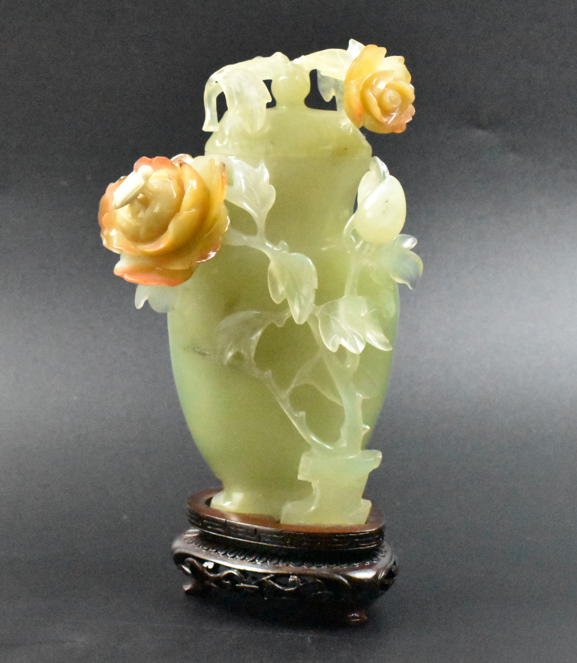 Appraisal: Chinese jade covered vase on a wooden stand The oval