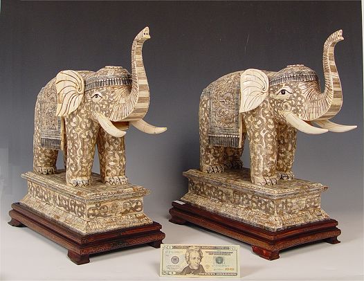 Appraisal: PAIR CHINESE CARVED AND IVORY CLAD SCRIMSHAW ELEPHANTS Detailed scrimshaw