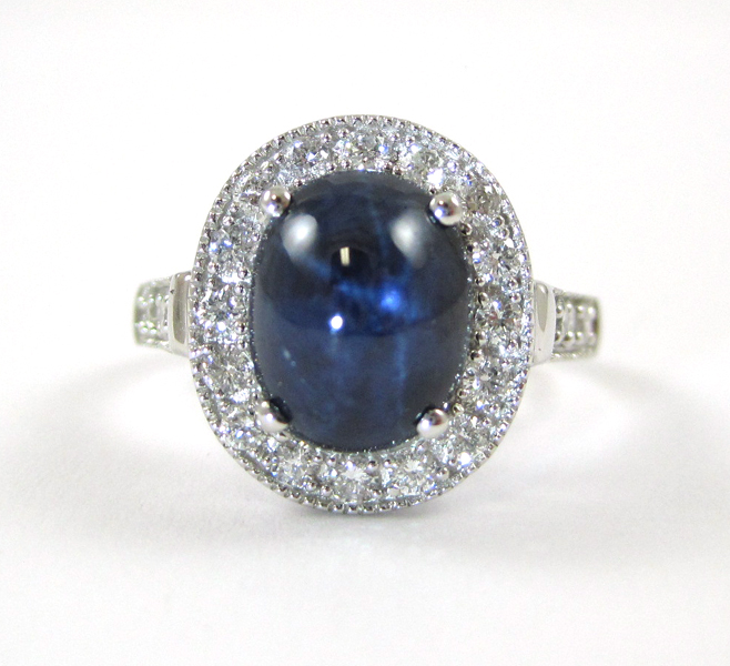 Appraisal: FOURTEEN KARAT WHITE GOLD STAR SAPPHIRE AND DIAMOND RING Oval