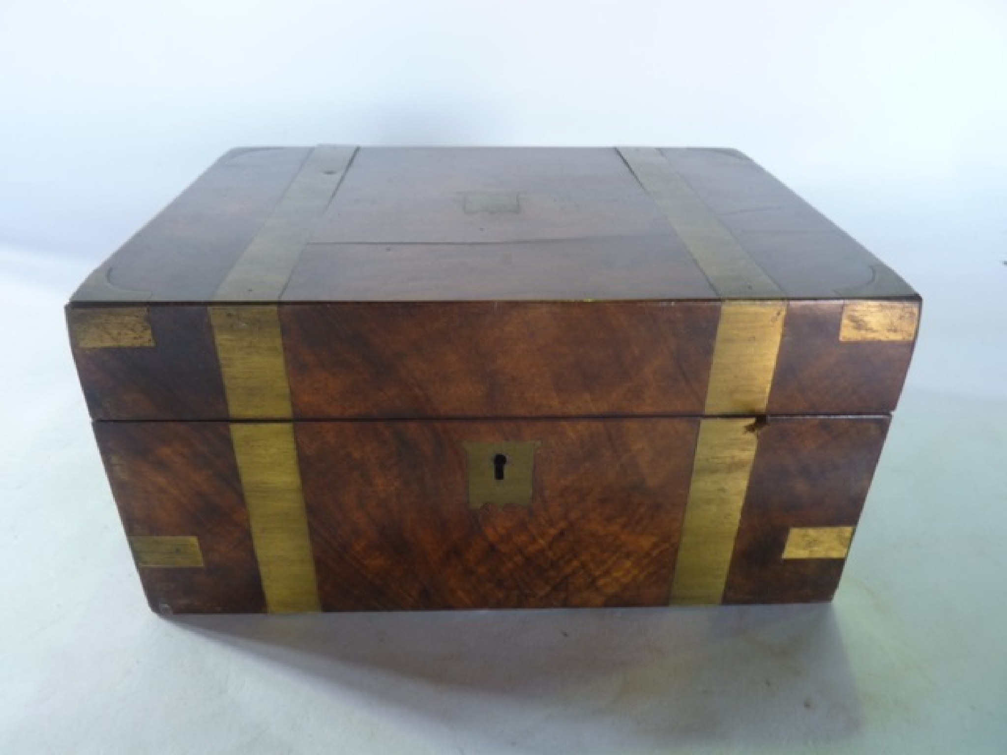 Appraisal: A Victorian mahogany veneered writing box with brass banded exterior