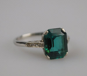 Appraisal: Single green stone ring platinum claw set with small diamonds