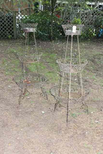 Appraisal: A PAIR OF GRADUATED THREE TIER WROUGHT IRON PLANT STANDS