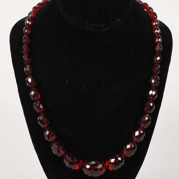 Appraisal: Faceted graduated red amber beaded necklace Approx