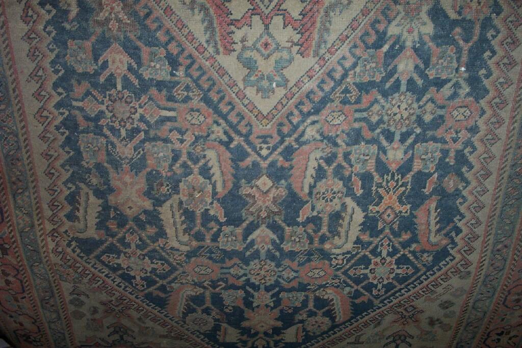 Appraisal: An eastern wool rug with red and cream decoration on