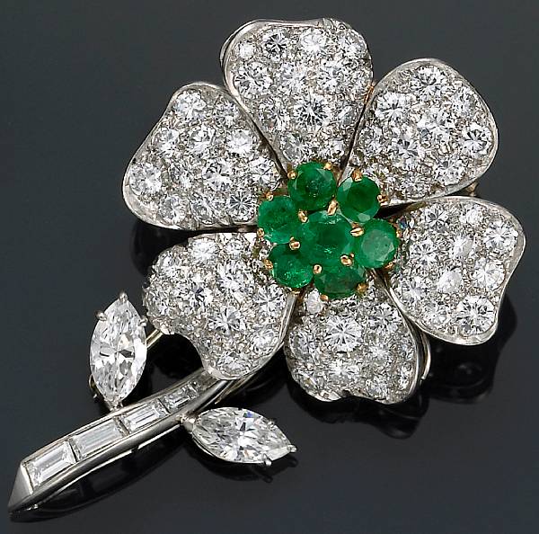 Appraisal: A diamond emerald platinum and eighteen karat gold flower brooch