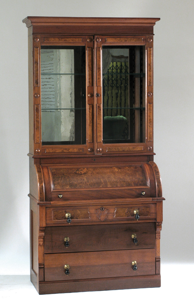 Appraisal: VICTORIAN WALNUT CYLINDER-FRONT SECRETARY BOOKCASE American c The top section