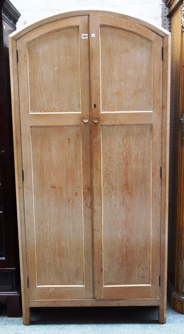 Appraisal: A th century limed oak arch top two door wardrobe