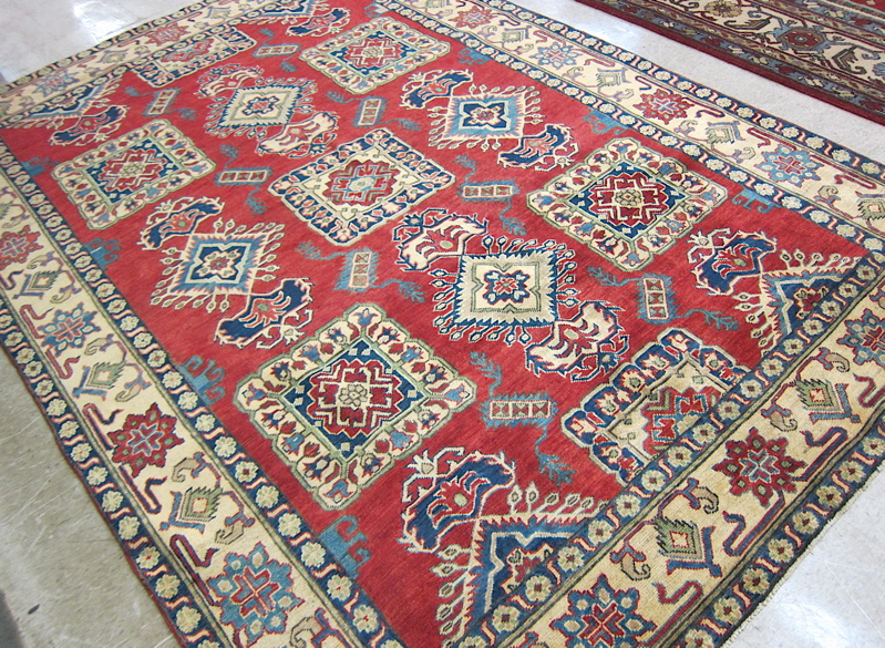 Appraisal: HAND KNOTTED ORIENTAL CARPET Pakistani-Caucasian the red field covered with