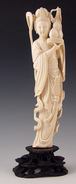 Appraisal: CHINESE CARVED IVORY FIGURE WOMAN HOLDING FRUIT Carved from single