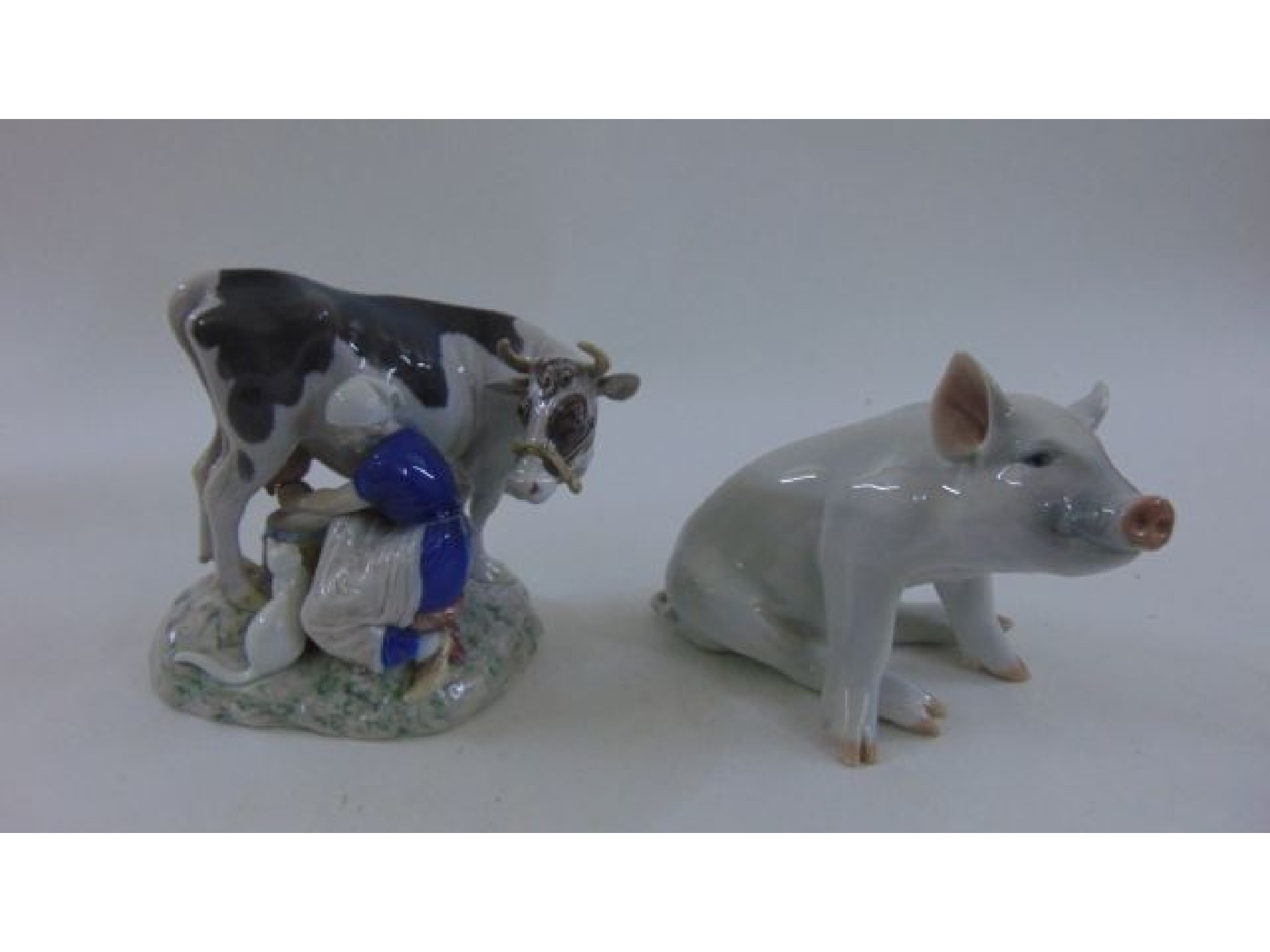 Appraisal: A Copenhagen figure of a seated sow number and a