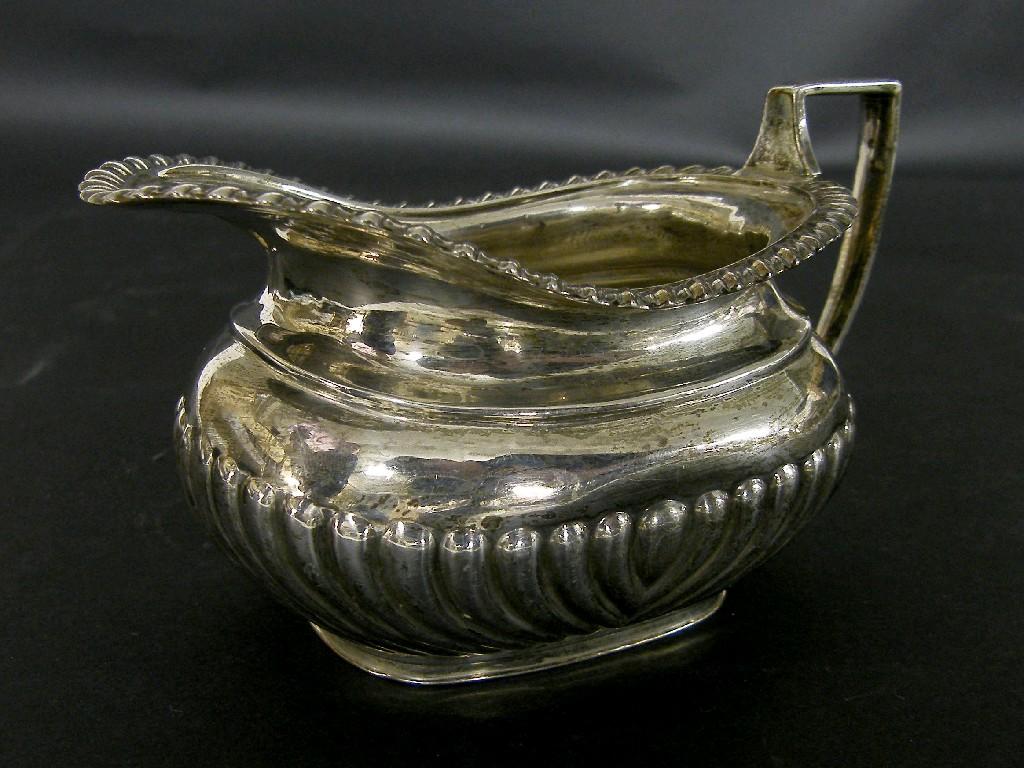 Appraisal: Late Edwardian Mappin Webb silver boat shaped half fluted milk