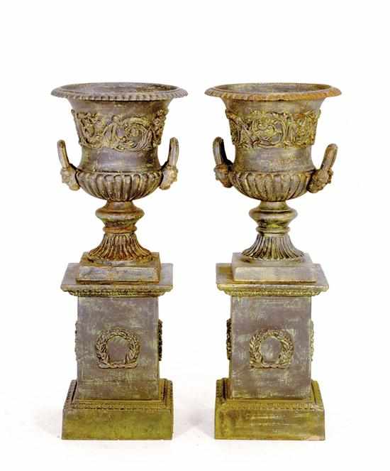 Appraisal: Pair cast-iron garden urns urn with flaring rim on square