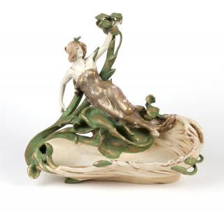 Appraisal: An Amphora pottery ''femme fleur'' centerpiece Circa Turn-Teplitz Bohemia impressed