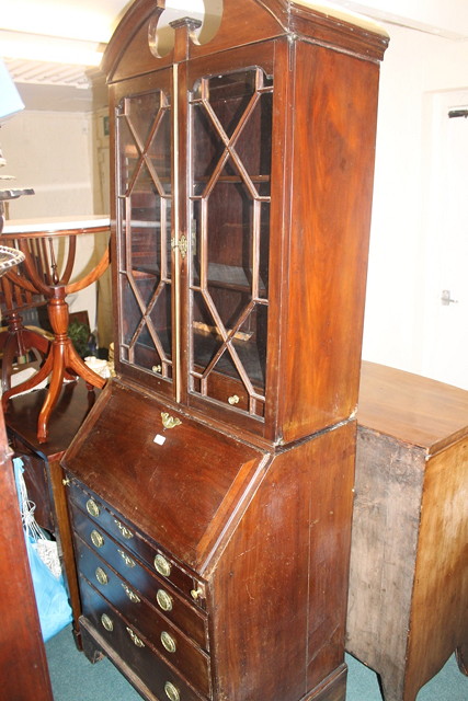 Appraisal: A MAHOGANY BUREAU BOOKCASE the upper section enclosed by two