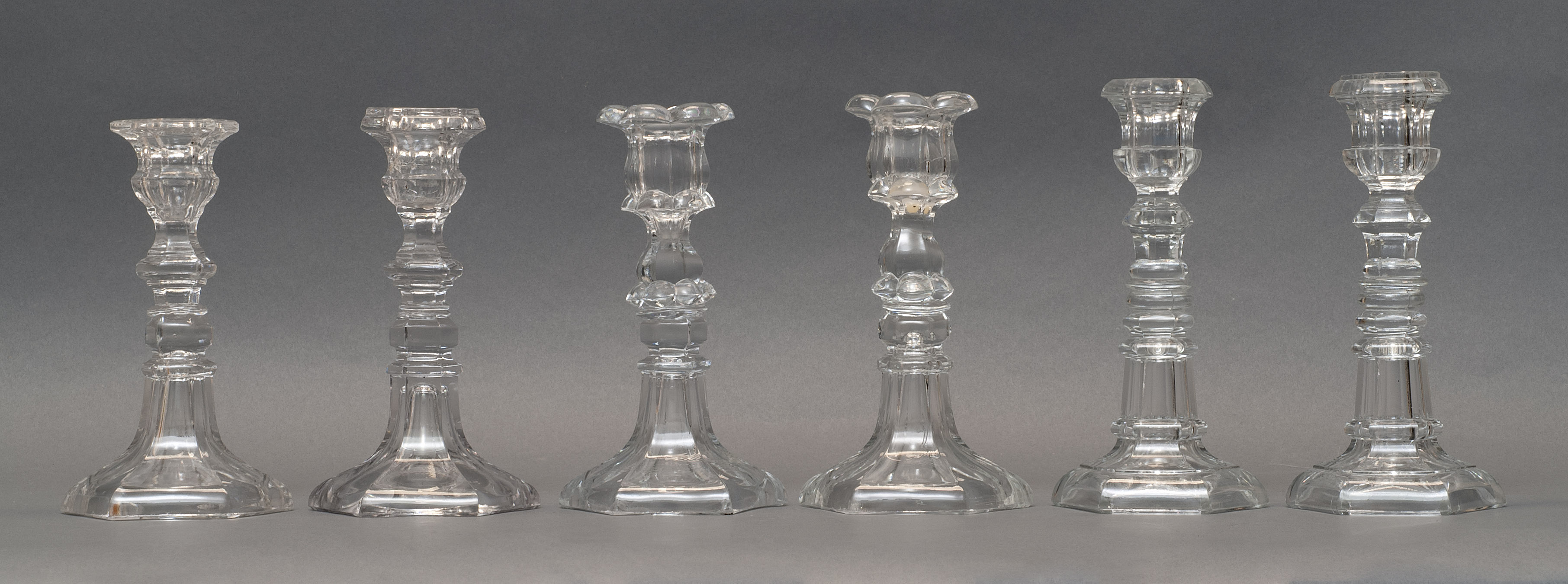 Appraisal: THREE PAIRS OF CLEAR PRESSED GLASS CANDLESTICKS th CenturyIn varied