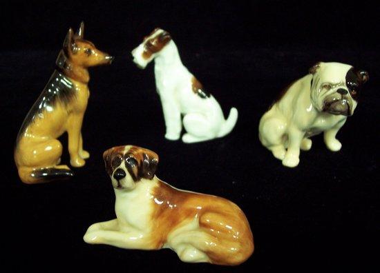 Appraisal: Four Royal Doulton dogs Bulldog K cm high Alsatian K