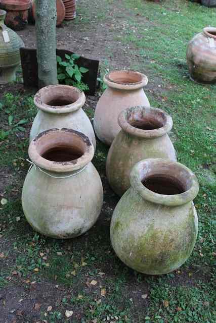 Appraisal: A SET OF FIVE OVOID TERRACOTTA JARS with flaring rims