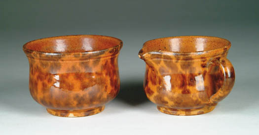 Appraisal: GLAZED REDWARE SUGAR AND CREAMER Orange ground interior and exterior