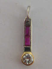 Appraisal: A round brilliant cut diamond and ruby pendant diamond approx