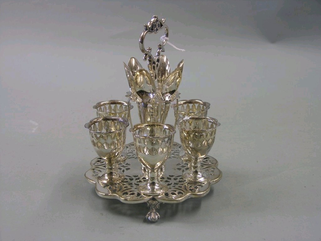 Appraisal: A silver plated egg cruet six egg cups and spoons