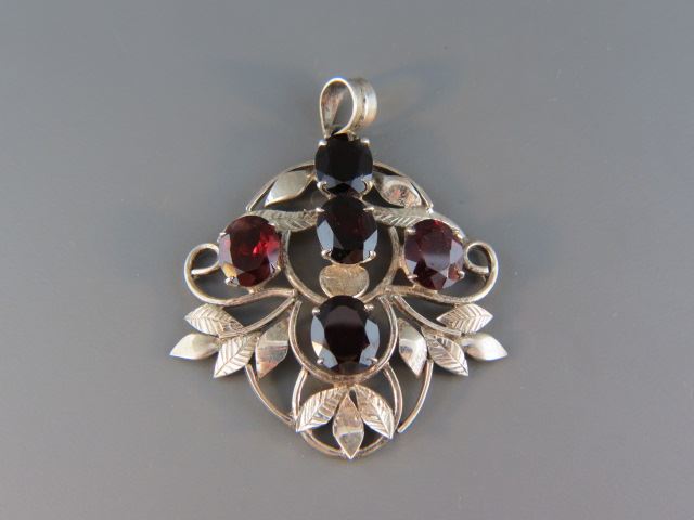 Appraisal: Garnet Sterling Silver Pendant five rich red oval gems totaling