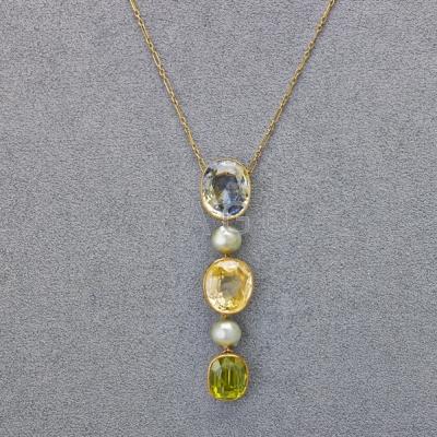 Appraisal: FANCY COLOR SAPPHIRE AND PERIDOT LAVALIER Oval blue yellow sapphire