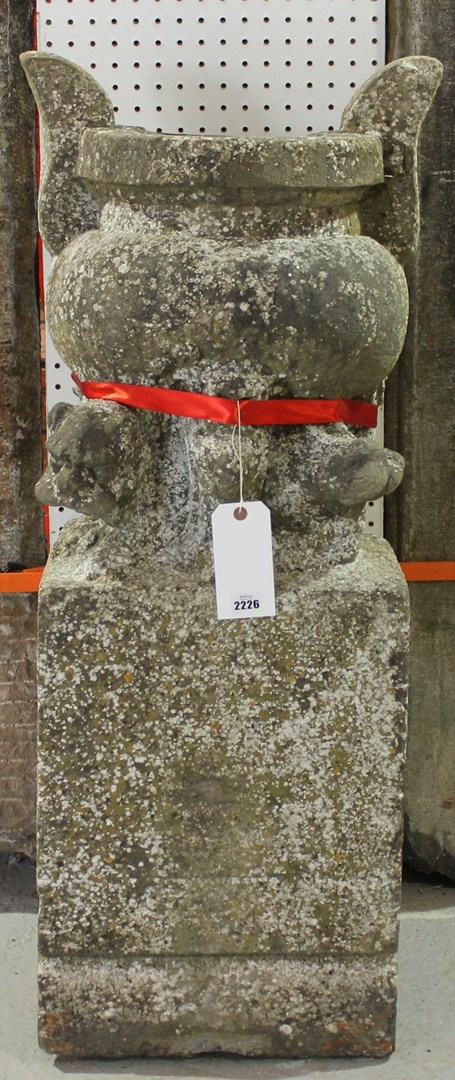 Appraisal: A granite mortar on a square base relief carved with